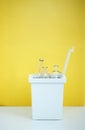 white bucket for sorting recyclables for glass on a yellow background