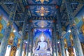 The white buddha statue inside the Hall in Blue temple Wat Rong Suea Ten