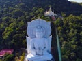 White Buddha statue in Wat Tham Phrathat Khao Prang, Lopburi, Thailand