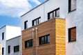 White building facade with wooden panels and plaster Royalty Free Stock Photo