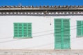 White building with green shutters in El Terreno Royalty Free Stock Photo