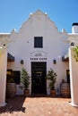 White building with an inviting entranceway featuring a front door. Farm cafe in Stellenbosch
