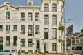 a white building with windows on a city street