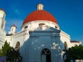 A white building with an orange dome left behind by the invaders and a dove on top of it