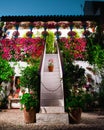 White building with a stairway decorated with beautiful and colorful flowers