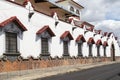 White building with windows and red gabled awning Royalty Free Stock Photo