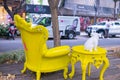 White bulldog statuette and vintage yellow table and armchair in park