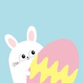 White bunny rabbit holding big painted egg. Happy Easter. Funny head face, eyes, ears. Cute kawaii cartoon character. Baby greetin Royalty Free Stock Photo