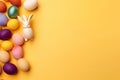 a white bunny sitting in a pile of colorful eggs on a yellow background with a place for text or image for a greeting card or a Royalty Free Stock Photo