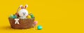 White bunny with wooden basket full of colorful eggs on yellow Easter background Royalty Free Stock Photo