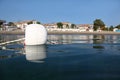 White buoy in salt water near beach