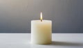 White burning candle white table. Gray backdrop Royalty Free Stock Photo