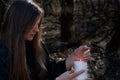 White burning Candle in woman`s hands in the middle of the forest. Hope and Pray concept. All Saints Day celebration. Witchcraft Royalty Free Stock Photo