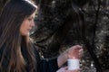 White burning Candle in woman`s hands in the middle of the forest. Hope and Pray concept. All Saints Day celebration. Witchcraft Royalty Free Stock Photo