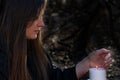 White burning Candle in woman`s hands in the middle of the forest. Hope and Pray concept. All Saints Day celebration. Witchcraft Royalty Free Stock Photo