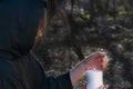 White burning Candle in woman`s hands in the middle of the forest. Hope and Pray concept. All Saints Day celebration. Witchcraft Royalty Free Stock Photo