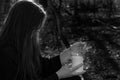 White burning Candle in woman`s hands in the middle of the forest. Hope and Pray concept. All Saints Day celebration. Witchcraft Royalty Free Stock Photo