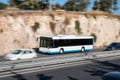 White bus moving fast along the street on a motion blurred background. Bus driving on freeway,