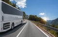 A white bus rides along the highway against the backdrop of a beautiful landscape Royalty Free Stock Photo