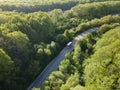 White bus on Road in beautiful summer forest aerial Royalty Free Stock Photo