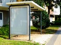 White bus shelter at a bus stop. glass light box side panel. ad mock-up template