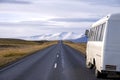 White bus on the side of a desert mountain road in Iceland Royalty Free Stock Photo