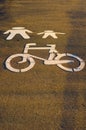 White bycicle and pedestrian symbols on a path. Pictogram imitating of walking figures, parent and child Royalty Free Stock Photo