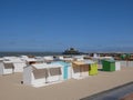 White cabanas or beach huts on a sandy beach