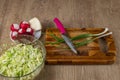 White cabbage, red radish, green onion, red beetroot, celery root, cutting board, knife and glass bowl for making fresh