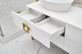 White cabinet with open drawer and vessel sink in bathroom Royalty Free Stock Photo