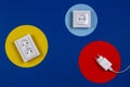 White cable and electrical sockets on geometric yellow red blue navy color background