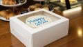 White Cake with Blue Happy New Year Icing in Box Royalty Free Stock Photo