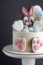 White cake with bunny gingerbread cookie on top