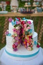 Wedding cake decorated with colorfull roses. Celebration party concept. flowers in the middle of the place where the cake is cut Royalty Free Stock Photo