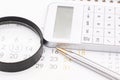 White calculator, calendar, and magnifying glass. The concept of planning. Business concept