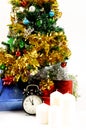 White caldle and clock with Christmas tree decoration on white b Royalty Free Stock Photo