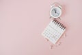 White calendar, thumbtacks and analog alarm clock with copy space Royalty Free Stock Photo