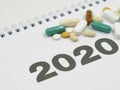 White calendar 2020 with various pills and copy space