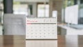 White calendar on a wooden table in the office Royalty Free Stock Photo