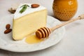 White Camembert cheese with honey, almonds and rosemary