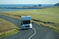 White camper driving on a road - front view Royalty Free Stock Photo