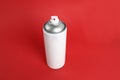 White can of spray paint on red background Royalty Free Stock Photo