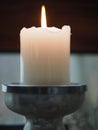 Burning lonely white candle with a fire flame Royalty Free Stock Photo