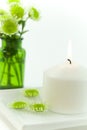 White candle and floating flowers Royalty Free Stock Photo