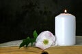 White candle, flower and book Royalty Free Stock Photo