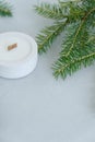 Flat lay Christmas tree Branches and Candle on Light Gray Background at Top of Frame. Copy Space Royalty Free Stock Photo