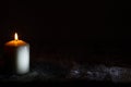 White candle in the night on wooden snowy board christmas abstract background with copy space Royalty Free Stock Photo