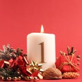 White candle with the number one burns, Advent background