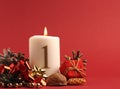 White candle with the number one burns, Advent background Royalty Free Stock Photo