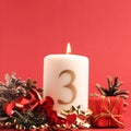 White candle with the number three burns, Advent background